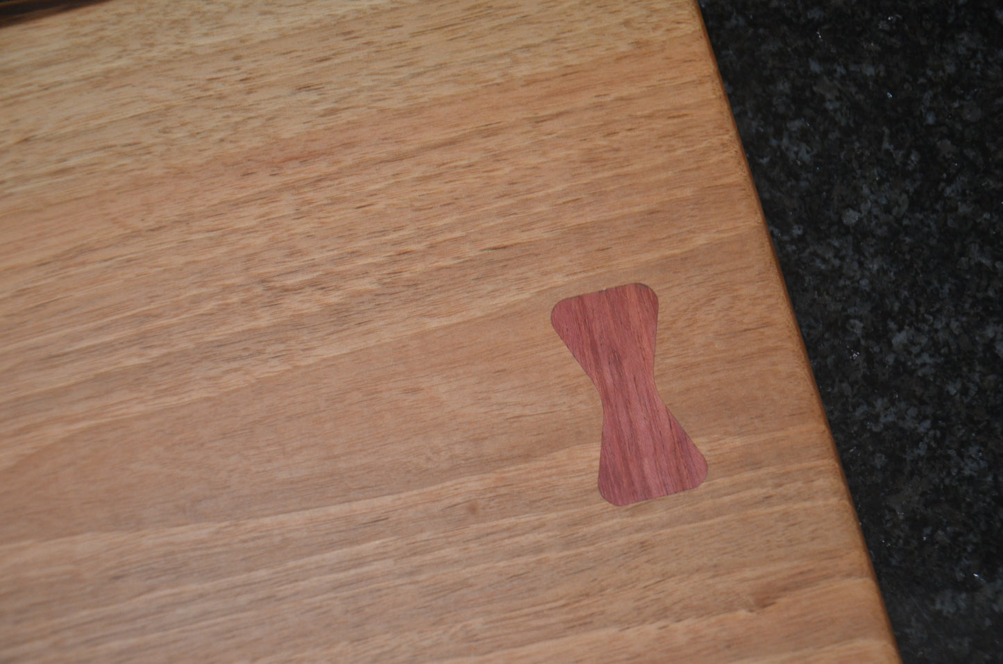 Walnut Chopping Board with Purple Heart and Cherry Bow Tie Inlays.